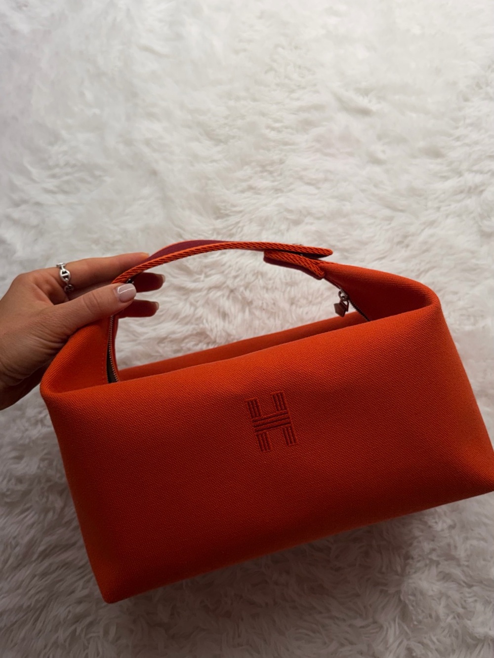 Hermès Bride-a-Brac canvas vanity bag in iconic Hermès orange.